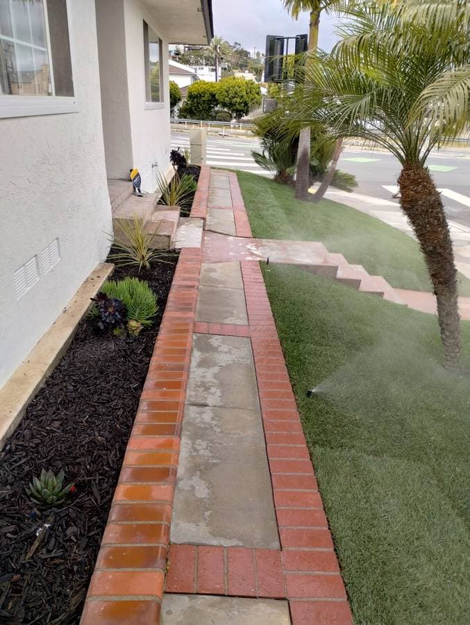 picture of newly installed pavers and grass and sprinkler system