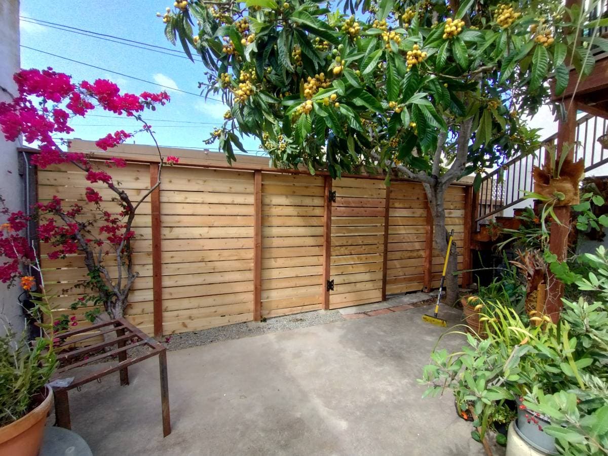picture of a newly remodeled wood fence with a back door